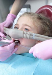Child getting dental work while inhaling nitrous oxide