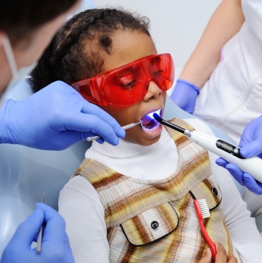 Child receiving dental sealants