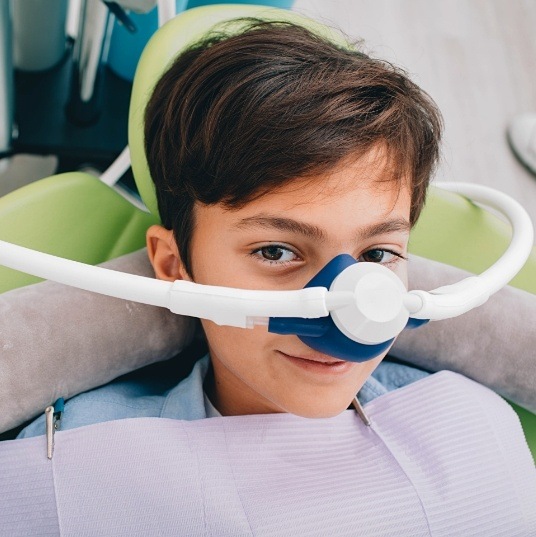 Child with nitrous oxide sedation dentistry mask in place