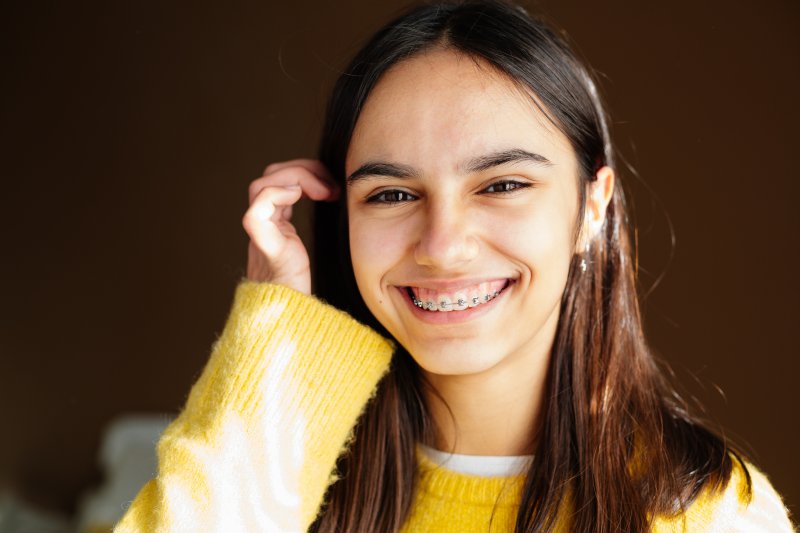 A young woman wearing braces and smling