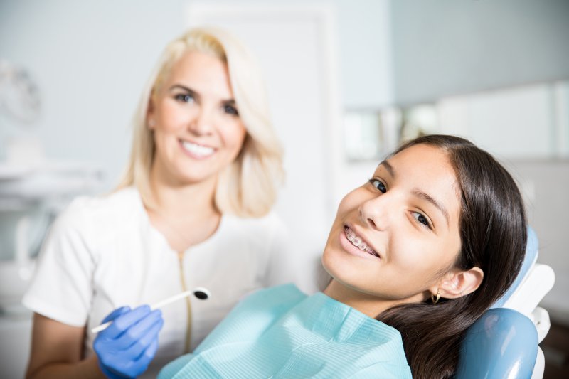 teen with braces sitting in a dental chair