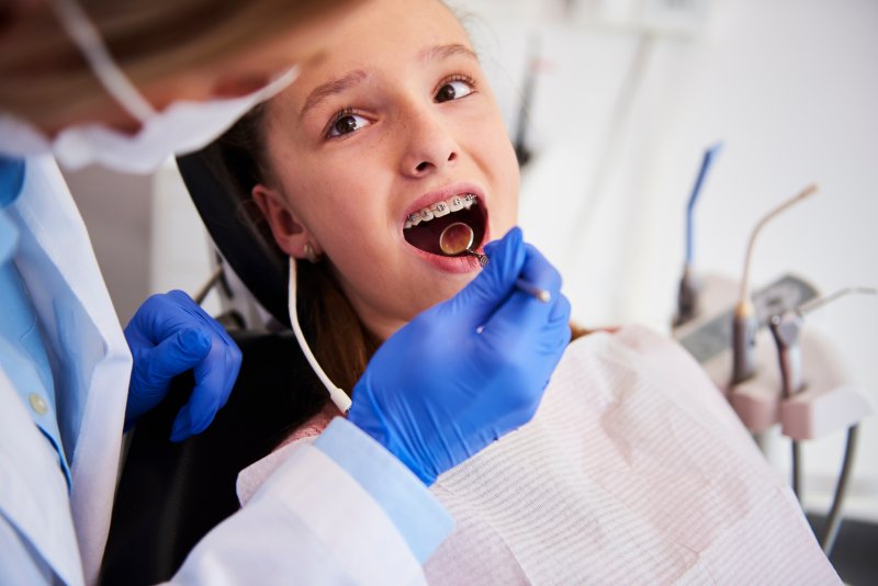 A child getting braces from their dentist